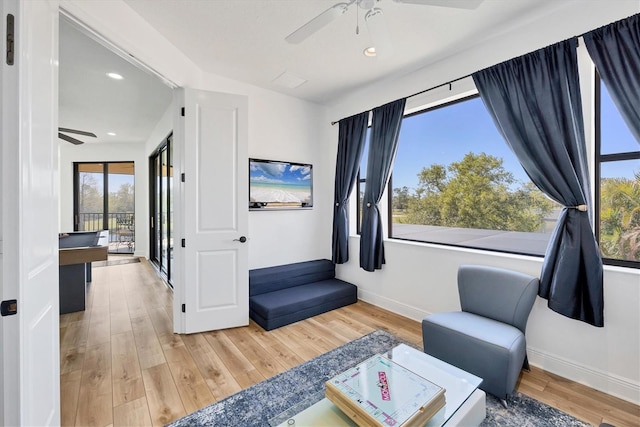 sitting room with recessed lighting, wood finished floors, baseboards, and ceiling fan