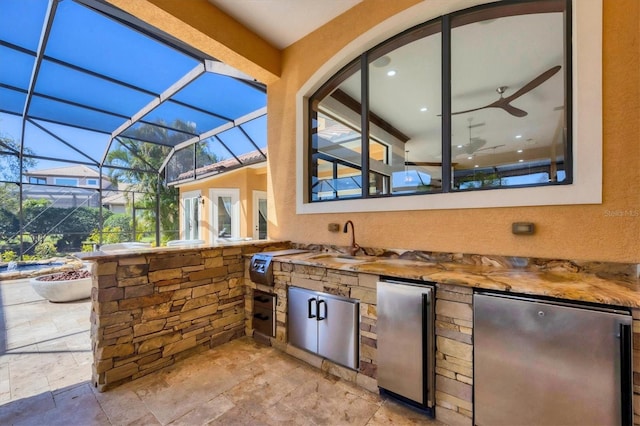 view of patio / terrace featuring a lanai, area for grilling, and a sink