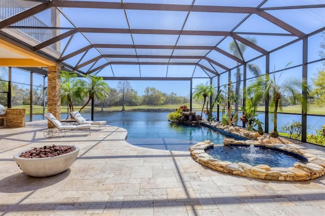 view of pool with glass enclosure, a water view, a pool with connected hot tub, and a patio area