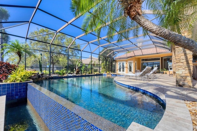 outdoor pool with a patio area and a lanai