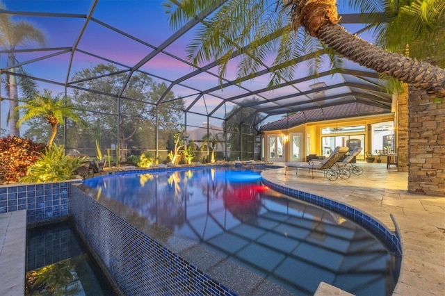 pool featuring a patio area and glass enclosure