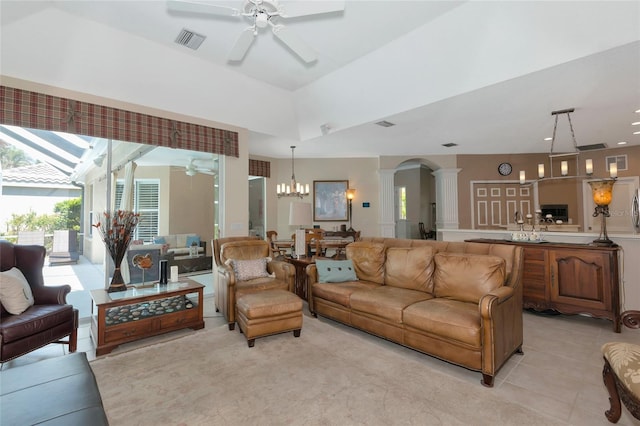 living area with visible vents, light tile patterned floors, ceiling fan with notable chandelier, arched walkways, and ornate columns