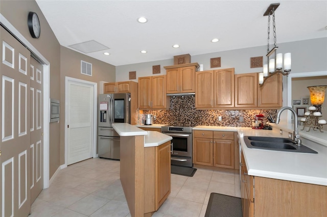 kitchen featuring a kitchen island, a sink, decorative backsplash, light countertops, and stainless steel appliances