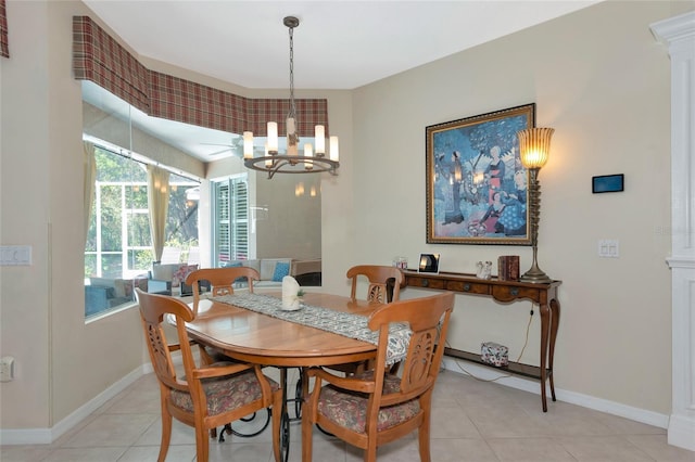 dining room with light tile patterned floors, baseboards, and a chandelier