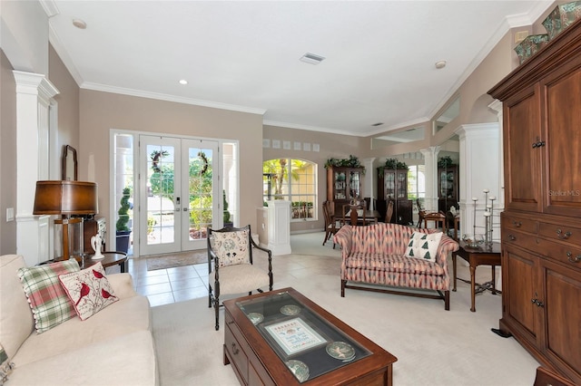 living room with decorative columns, french doors, visible vents, and light tile patterned floors