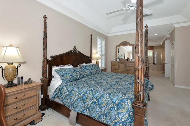 bedroom featuring ceiling fan, a tray ceiling, carpet flooring, and ornamental molding