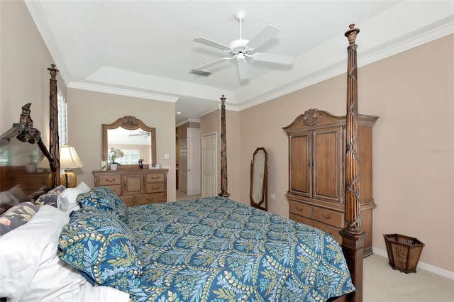 bedroom featuring baseboards, visible vents, a tray ceiling, ornamental molding, and light carpet