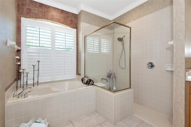 full bathroom featuring tile patterned flooring, crown molding, a garden tub, and a tile shower