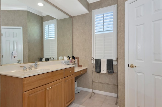 bathroom featuring tile patterned floors, vanity, baseboards, and ornamental molding