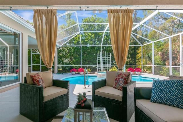 view of pool featuring glass enclosure, a pool with connected hot tub, outdoor lounge area, and a patio area