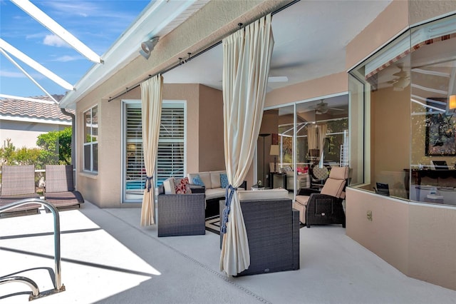 view of patio with an outdoor living space and glass enclosure