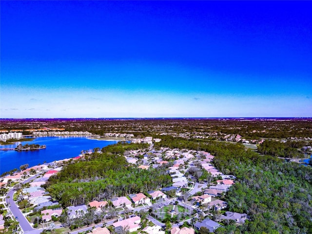 drone / aerial view with a residential view and a water view