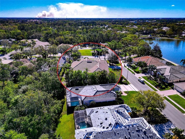 bird's eye view with a forest view and a water view