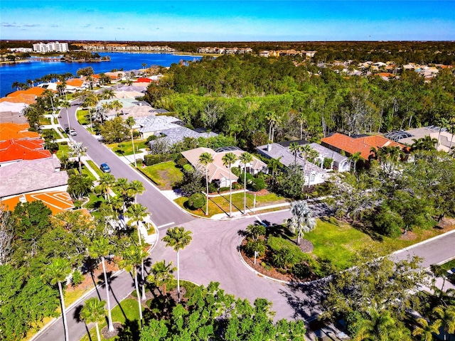 drone / aerial view with a residential view and a water view