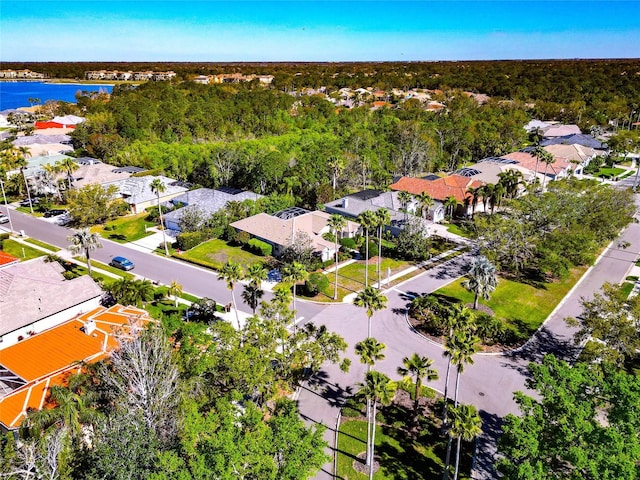 bird's eye view featuring a forest view, a residential view, and a water view