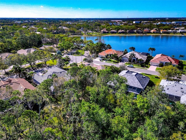 drone / aerial view featuring a residential view and a water view