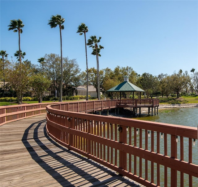 view of dock with a gazebo and a water view