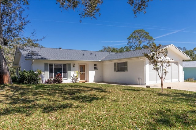 single story home with an attached garage, stucco siding, concrete driveway, and a front yard