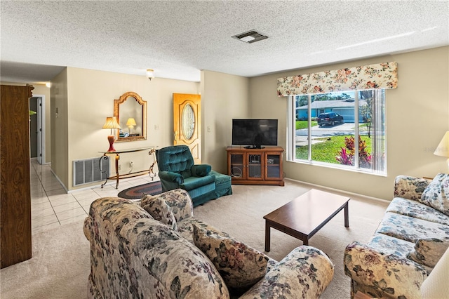 tiled living room featuring a textured ceiling, carpet floors, and visible vents