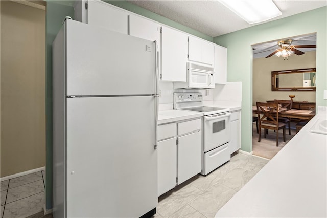 kitchen featuring white appliances, a ceiling fan, white cabinets, light countertops, and tasteful backsplash