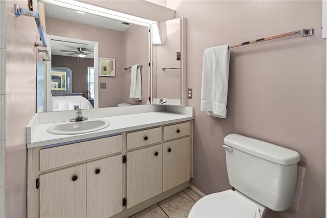 bathroom featuring ensuite bathroom, ceiling fan, toilet, vanity, and marble finish floor