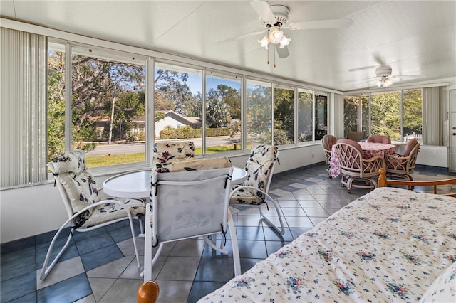 sunroom featuring ceiling fan