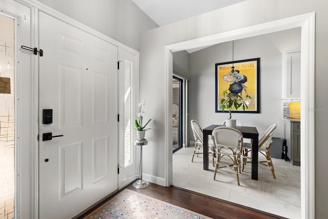 foyer entrance featuring wood finished floors and baseboards