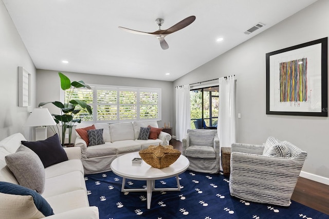 living room with lofted ceiling, visible vents, wood finished floors, and recessed lighting