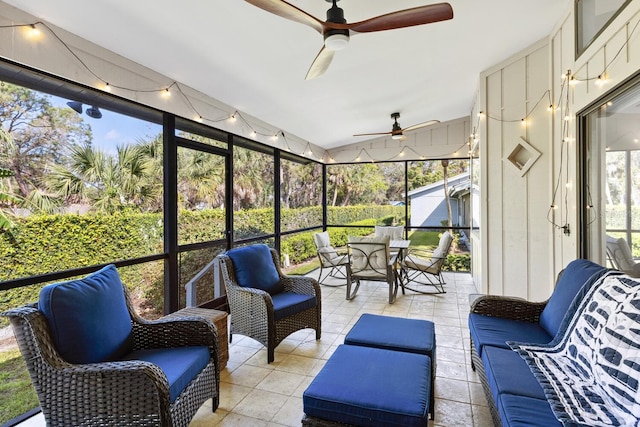 sunroom / solarium with a ceiling fan, lofted ceiling, and a healthy amount of sunlight