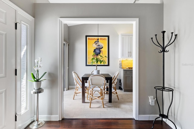 dining area featuring baseboards and wood finished floors