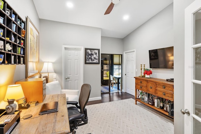 office featuring brick floor, a ceiling fan, and baseboards