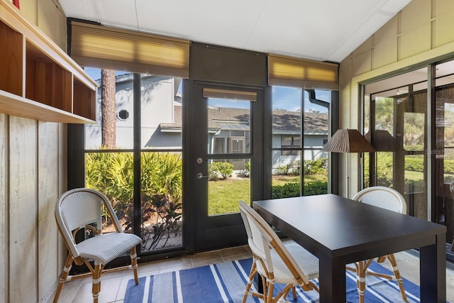 sunroom / solarium with a healthy amount of sunlight and lofted ceiling