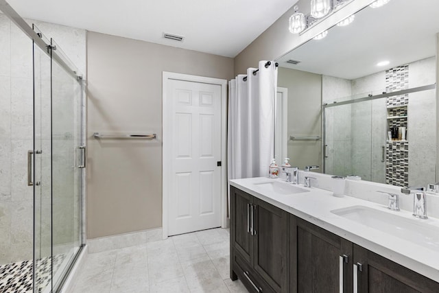 bathroom with a stall shower, visible vents, a sink, and double vanity