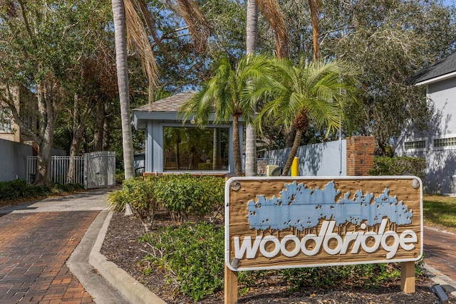 community sign with a gate and fence