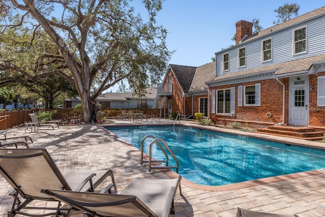 view of pool with a fenced in pool, a patio, and fence