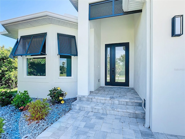 view of exterior entry with stucco siding