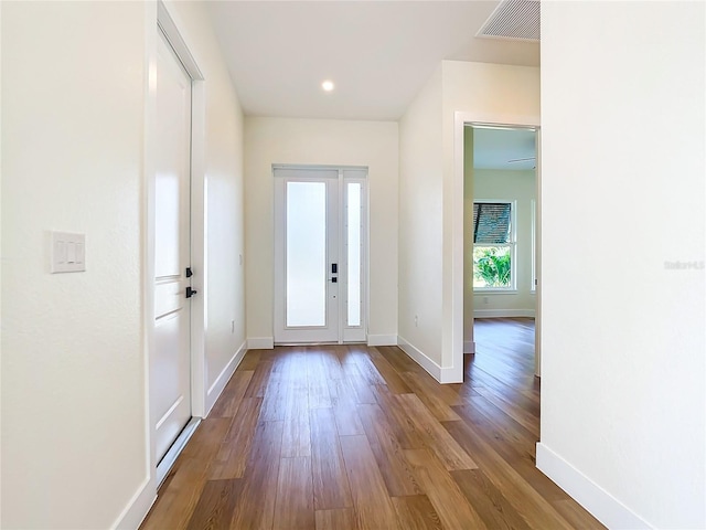 foyer featuring recessed lighting, visible vents, baseboards, and wood finished floors