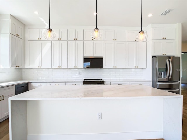 kitchen featuring tasteful backsplash, visible vents, a kitchen island, light stone counters, and black appliances