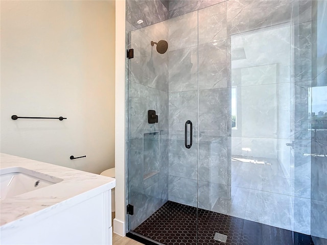 bathroom featuring a stall shower and vanity