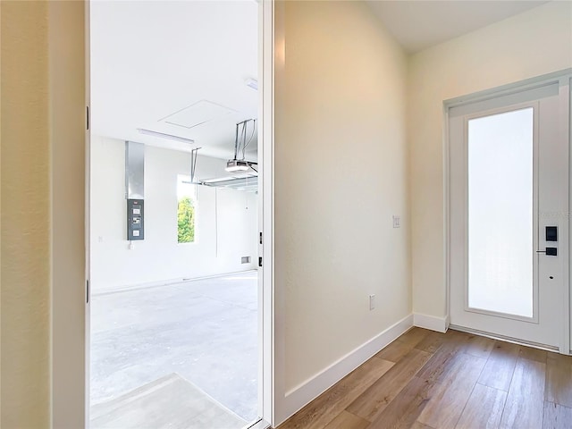 entryway with baseboards and wood finished floors