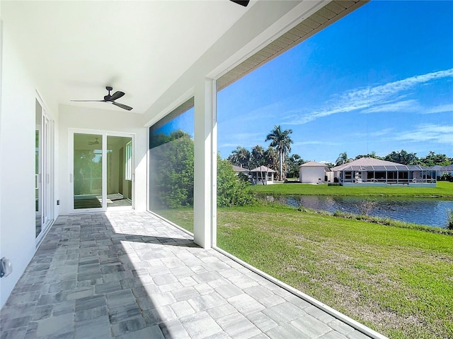 view of patio with a ceiling fan and a water view