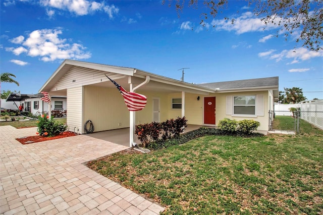 ranch-style house with a front lawn and fence