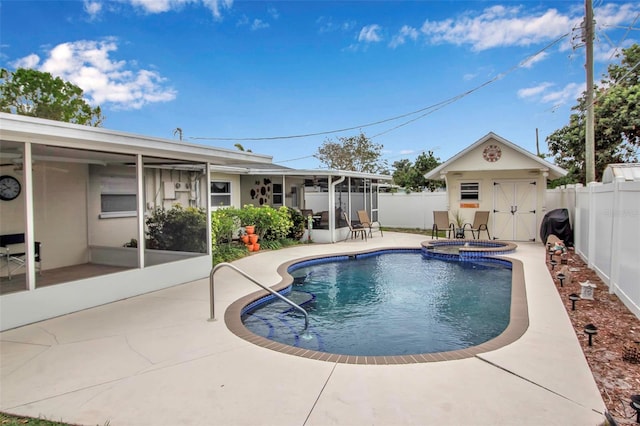 view of pool featuring a patio, an outdoor structure, a fenced backyard, and a pool with connected hot tub