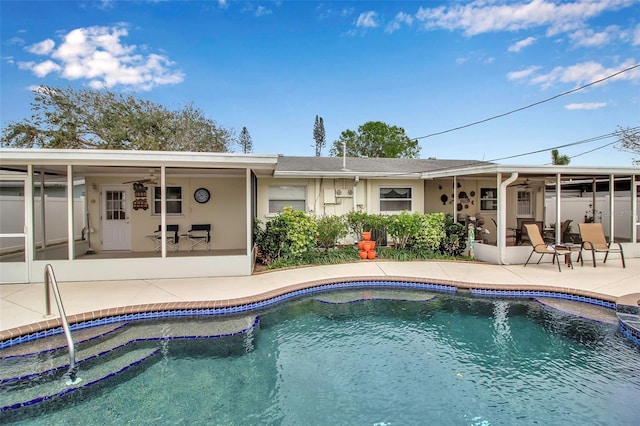 pool with a ceiling fan and a patio area