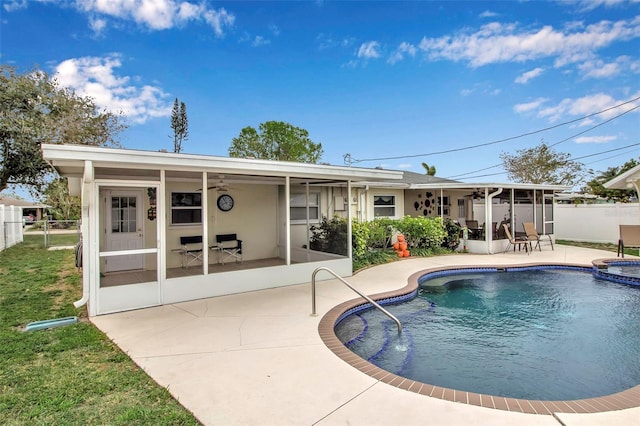 view of pool featuring a patio area, fence, a sunroom, and ceiling fan