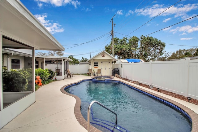 view of swimming pool featuring a patio, a fenced backyard, a sunroom, a pool with connected hot tub, and an outdoor structure