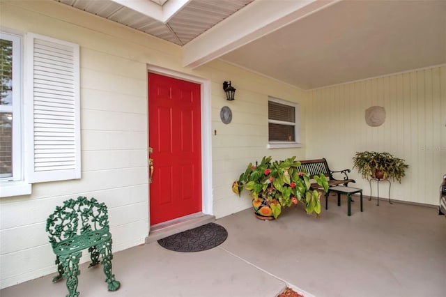 view of exterior entry with a porch