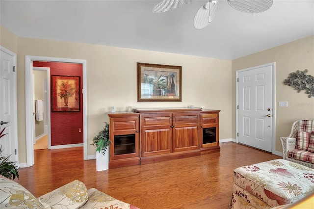 living area with light wood-style floors and baseboards