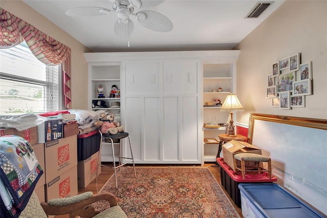 interior space with visible vents, wood finished floors, and a ceiling fan