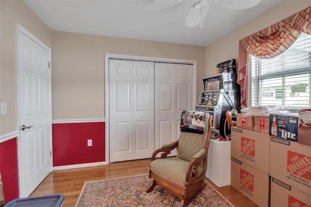 sitting room featuring light wood-type flooring and ceiling fan